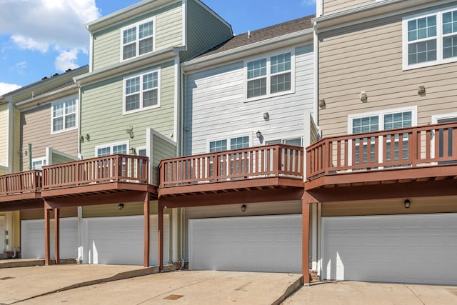 rear view of property with a garage and a deck