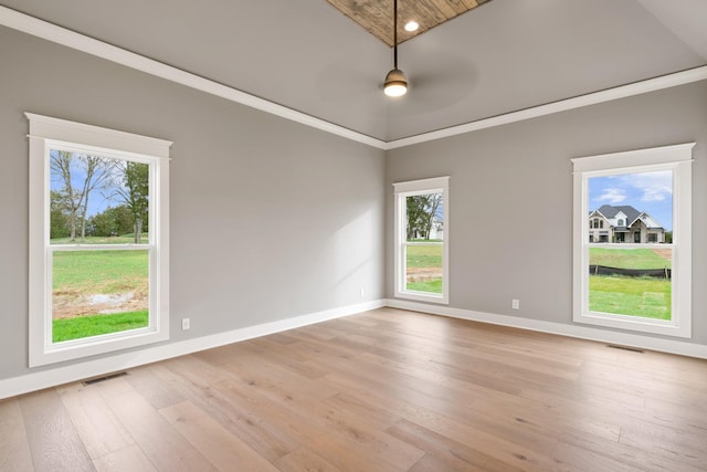 empty room with light hardwood / wood-style flooring, ceiling fan, and crown molding