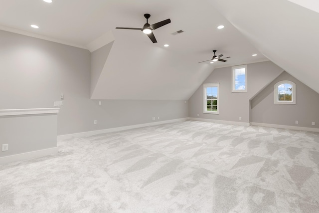 bonus room featuring ceiling fan, light colored carpet, plenty of natural light, and vaulted ceiling