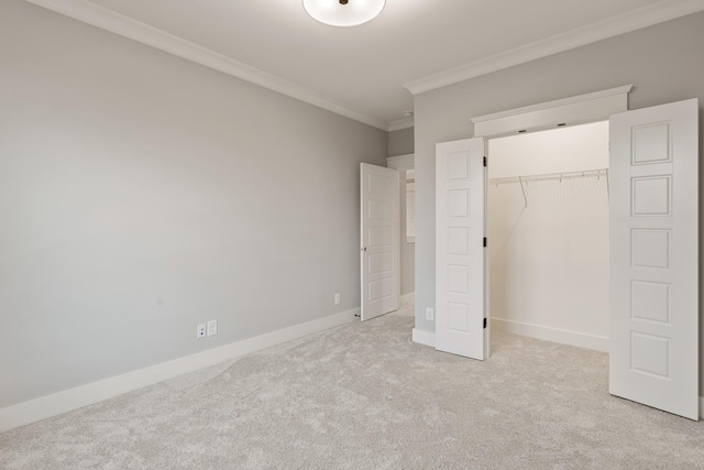 unfurnished bedroom with light colored carpet, ornamental molding, and a closet