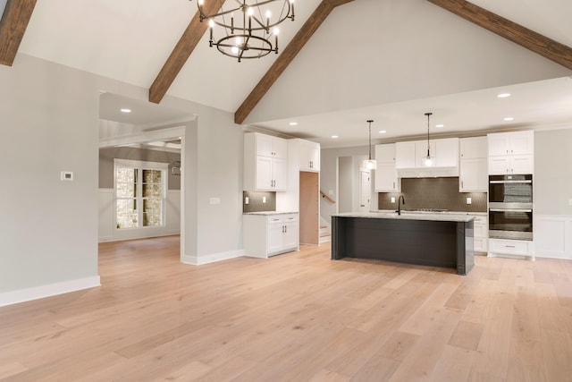 kitchen with decorative backsplash, decorative light fixtures, white cabinetry, and double oven