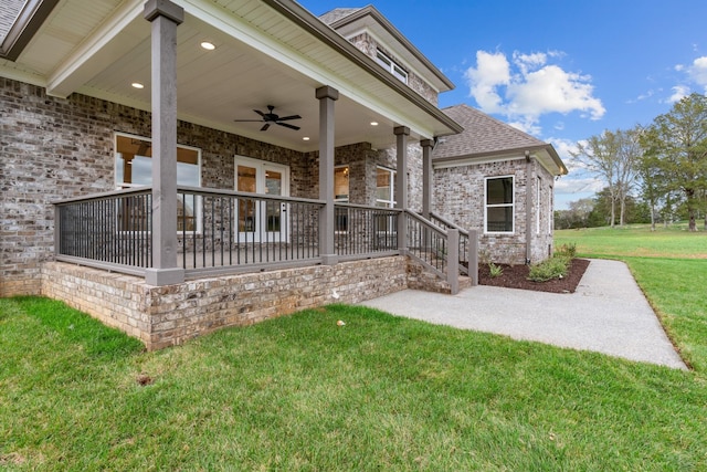 back of house featuring ceiling fan, a yard, and a patio