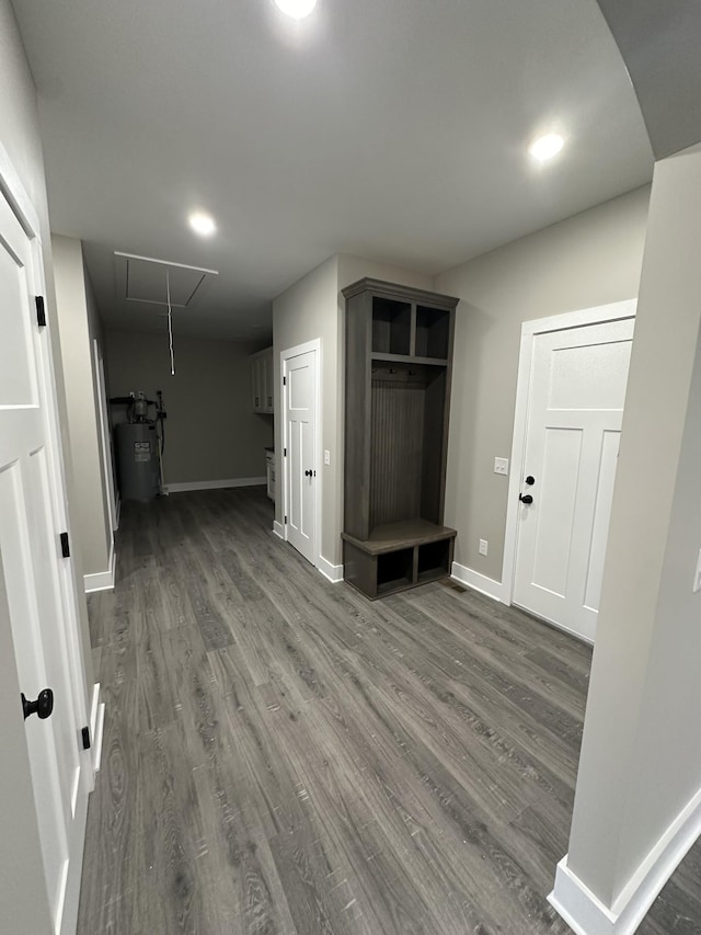 interior space with dark hardwood / wood-style floors and water heater