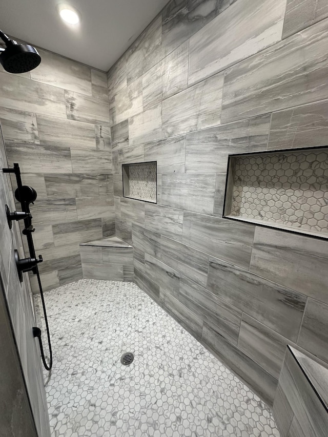 bathroom with a tile shower