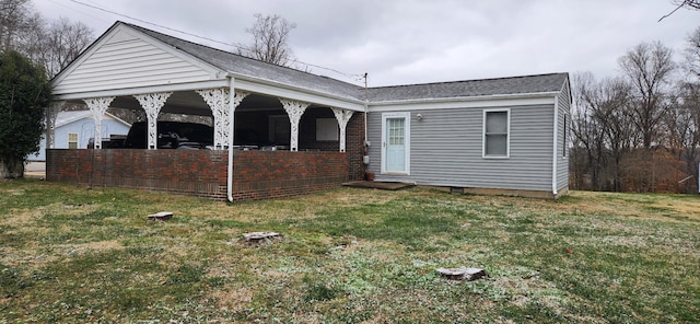 rear view of house featuring a yard