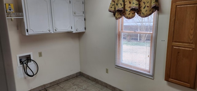 clothes washing area with hookup for a washing machine and cabinets