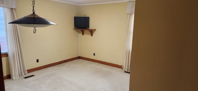 unfurnished room with crown molding and light carpet