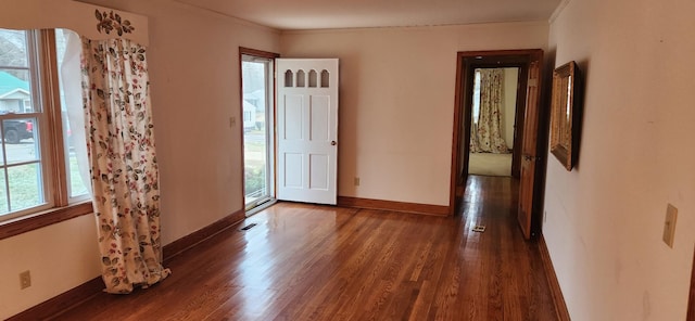 unfurnished room with dark hardwood / wood-style flooring and ornamental molding