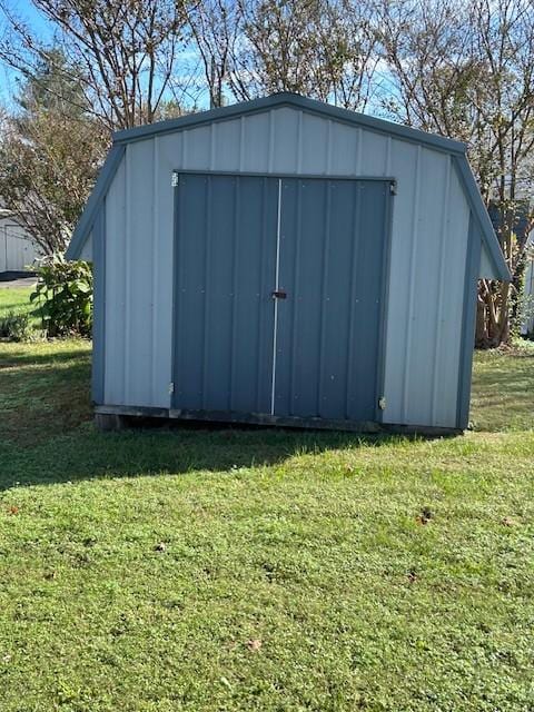 view of outbuilding featuring a lawn