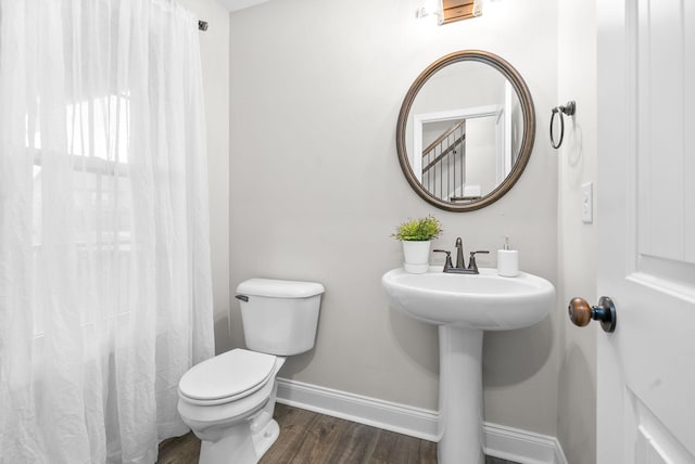 bathroom featuring hardwood / wood-style floors, toilet, and sink