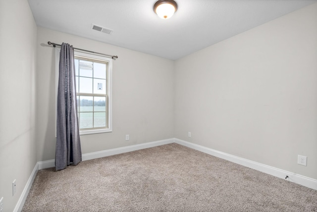 unfurnished room featuring carpet