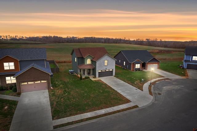 view of front facade featuring a garage and a yard