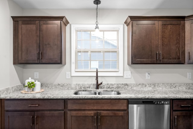 kitchen featuring dishwasher, dark brown cabinetry, sink, and decorative light fixtures