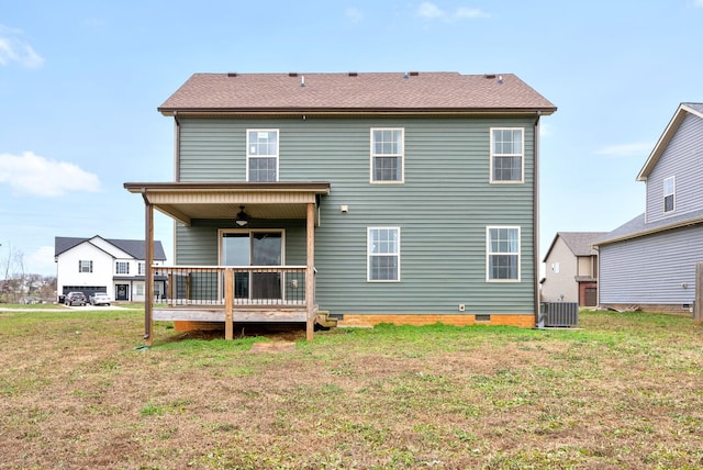 back of property with central AC unit, ceiling fan, and a lawn