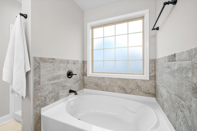 bathroom featuring plenty of natural light and a bathing tub