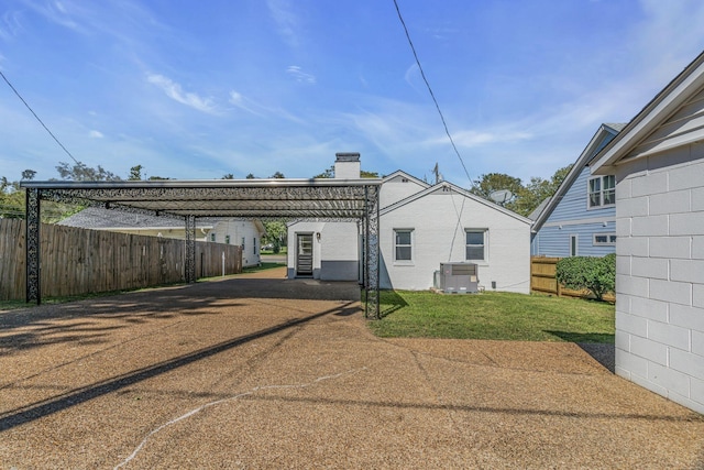 back of house featuring a lawn and cooling unit