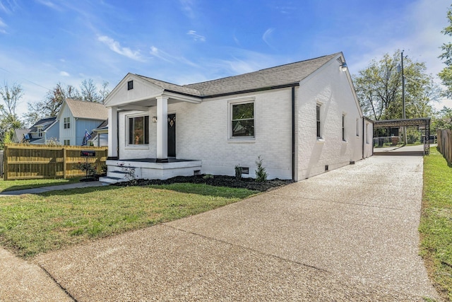 view of front facade with a carport and a front yard