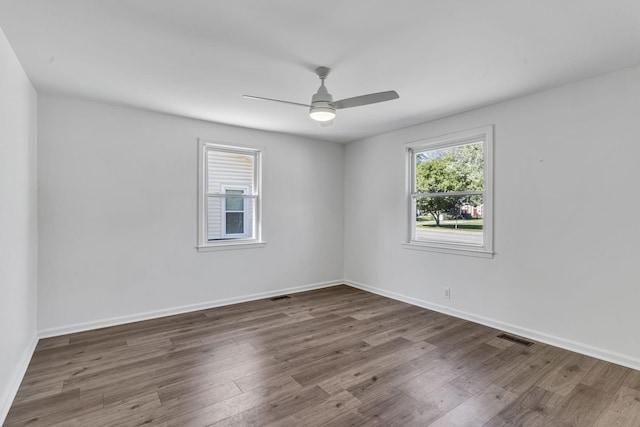 unfurnished room with dark hardwood / wood-style flooring and ceiling fan