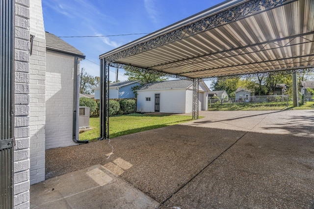 view of patio with a carport, an outdoor structure, and central air condition unit