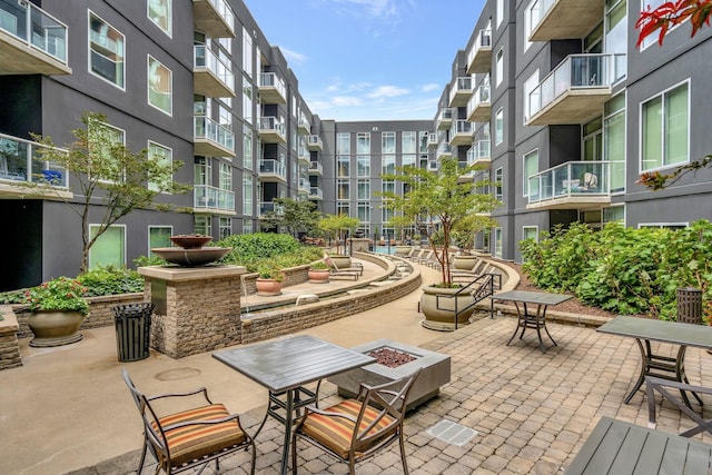 surrounding community featuring an outdoor fire pit