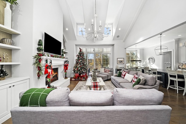 living room with dark hardwood / wood-style flooring, high vaulted ceiling, and an inviting chandelier