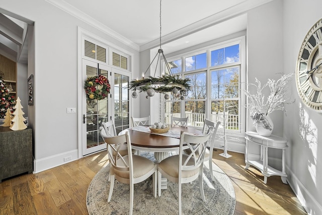 dining room featuring crown molding, french doors, and hardwood / wood-style flooring