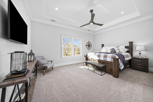 carpeted bedroom featuring a raised ceiling, ceiling fan, and crown molding