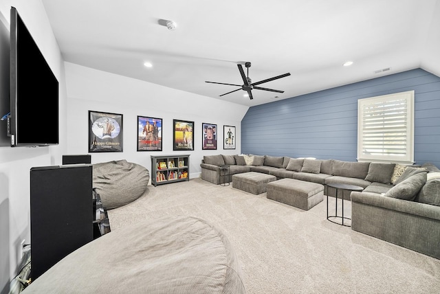 home theater featuring wood walls, carpet floors, vaulted ceiling, and ceiling fan