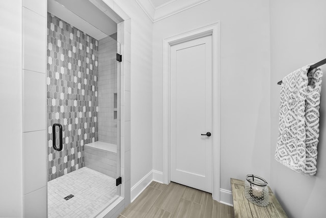 bathroom featuring ornamental molding and walk in shower