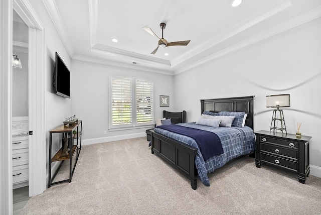 bedroom featuring light carpet, a tray ceiling, ceiling fan, and ornamental molding