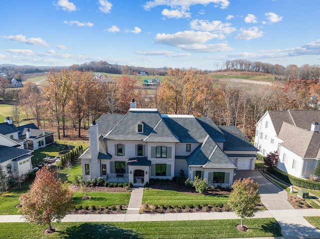 view of front of house featuring a garage and a front lawn