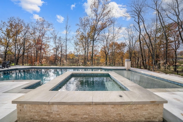 view of pool with an in ground hot tub