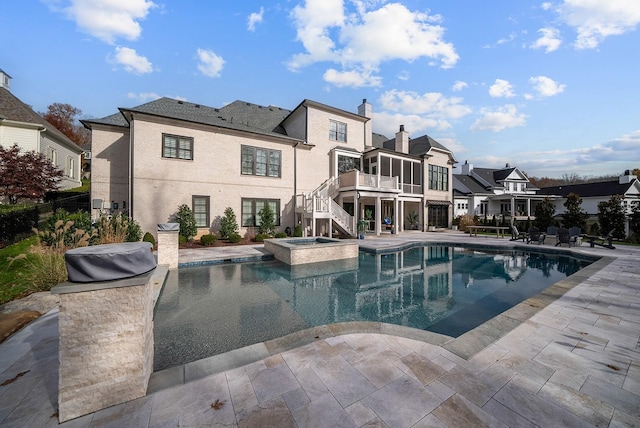 view of pool featuring an in ground hot tub and a patio