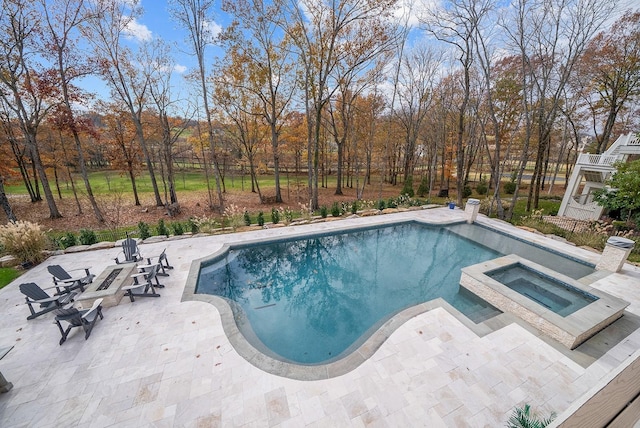 view of swimming pool featuring a patio area and an in ground hot tub