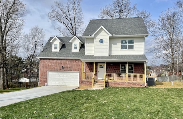 view of front of house featuring covered porch, a garage, and a front lawn