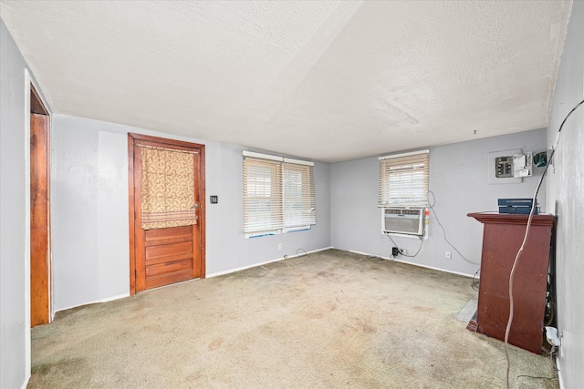 interior space featuring a textured ceiling, carpet floors, and cooling unit