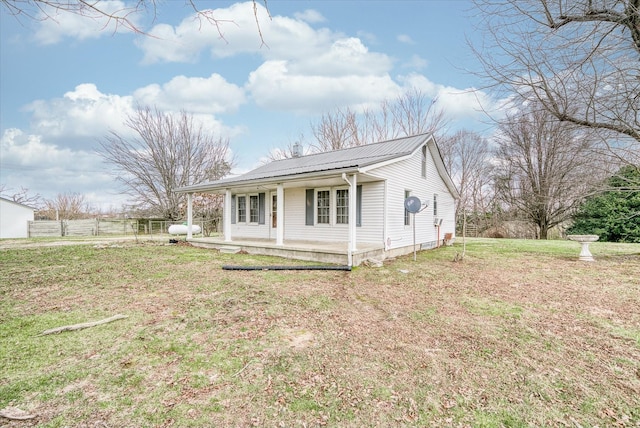 ranch-style home with covered porch and a front yard