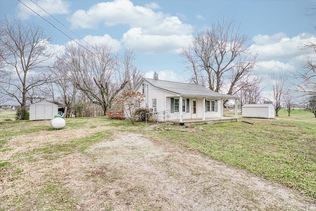 view of property exterior featuring a storage unit, a porch, and a yard