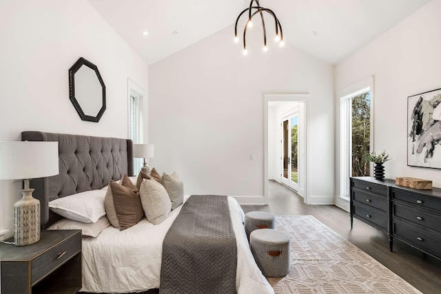 bedroom featuring wood-type flooring, access to outside, and vaulted ceiling