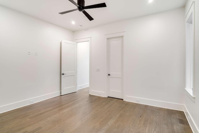 unfurnished bedroom with ceiling fan and light wood-type flooring