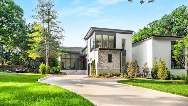 modern home featuring a front yard