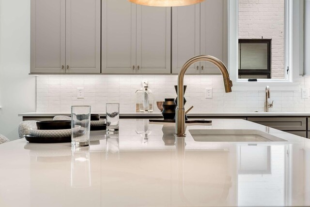 kitchen with gray cabinets and decorative backsplash