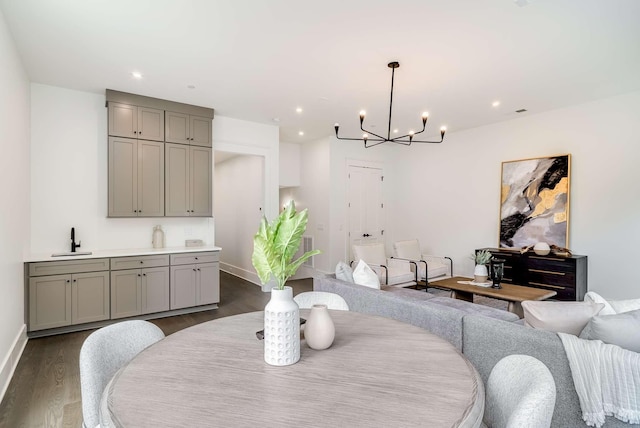 dining room with a chandelier, dark hardwood / wood-style flooring, and sink