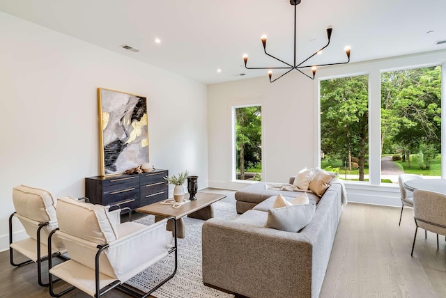 living room featuring a notable chandelier and wood-type flooring