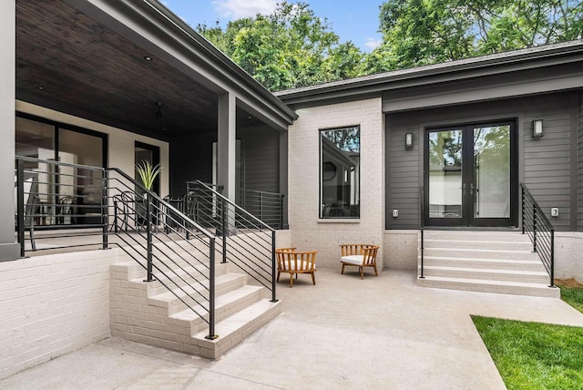 view of exterior entry featuring a patio area and french doors