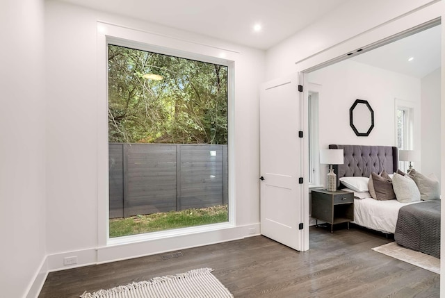 unfurnished bedroom with dark hardwood / wood-style flooring