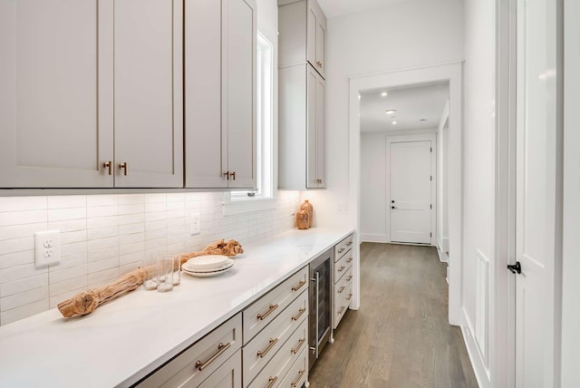 kitchen featuring backsplash, wine cooler, dark hardwood / wood-style flooring, and gray cabinetry