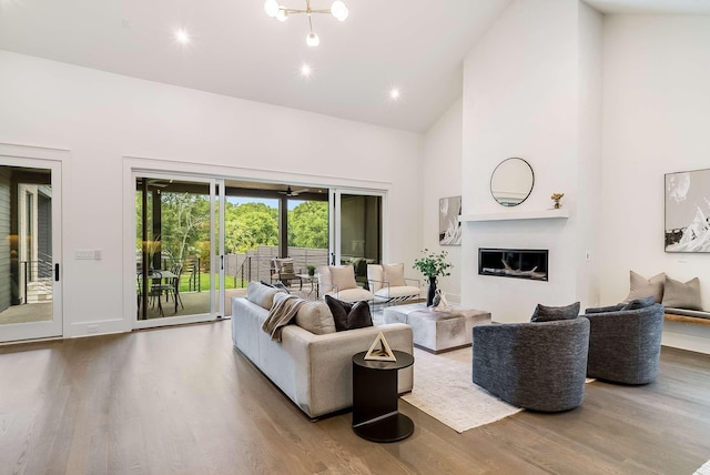 living room featuring hardwood / wood-style floors and high vaulted ceiling