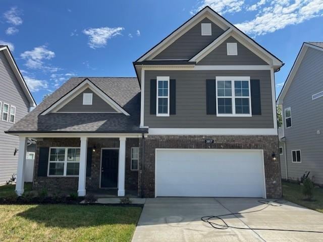 craftsman house featuring a garage and a front yard