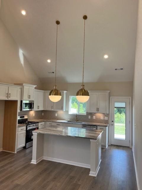 kitchen with white cabinetry, a center island, pendant lighting, and appliances with stainless steel finishes